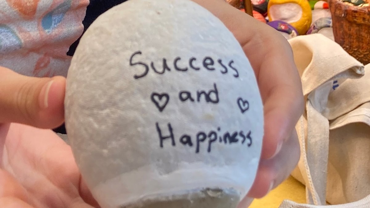 Writing a wish on a handmade daruma in Tokyo