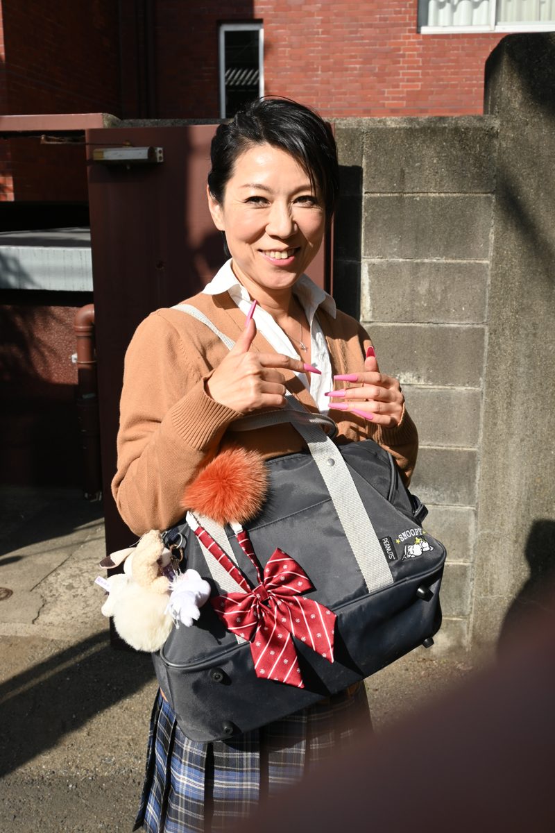 Guest in a uniform-style gyaru outfit on a Shibuya street